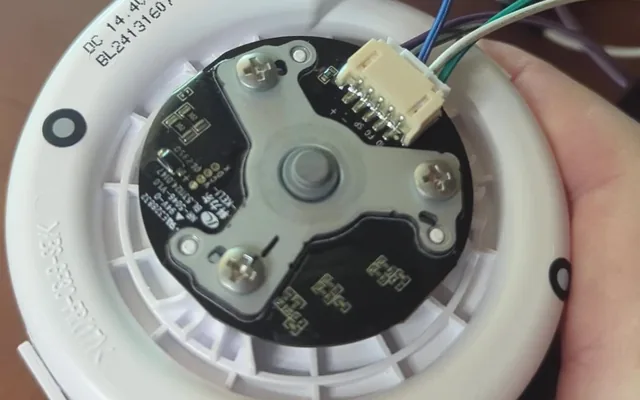 A robot vacuum suction fan wired up for testing
